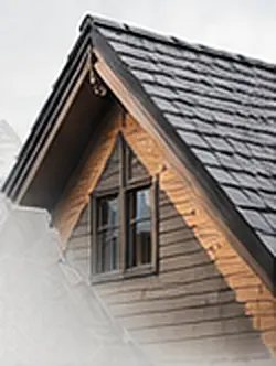 Close view of a shingled gable roof with a small dormer window